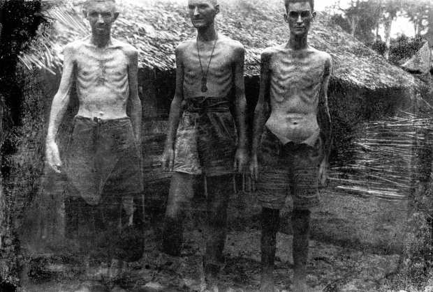 Three prisoners at Shimo Songkurai in 1943. The effects of malnutrition can be seen in their skeletal frames and the stomach of the man on the right, distended by beri beri. The photograph was one of the last to be taken by George Aspinall on the camera he smuggled up to the Thai–Burma railway from Changi. [By courtesy Tim Bowden]