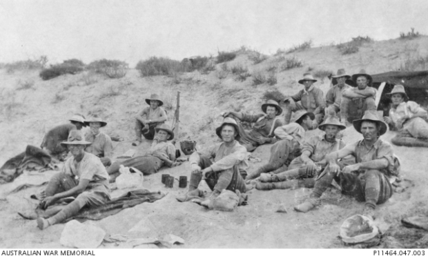 Group portrait of men of the 7th Australian Light Horse Regiment, resting in the sand near Asluj before the charge at Beersheba